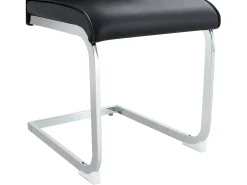 Juego de 4 sillas de comedor con patas de metal plateadas y piel sintética negra.