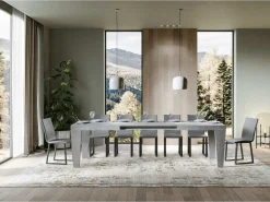Mesa de comedor extensible de madera Kristo patas en V-Color Gris cemento-Base y soporte con ruedas-5 alargaderas finas-Ancho extensible